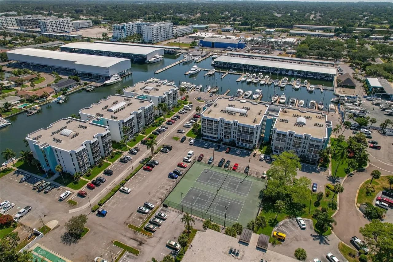 Aerial showing buildings, tennis courts, and marina